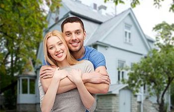 Young couple in front of the house