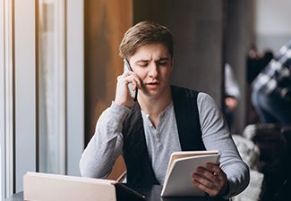 A man on the phone filing for divorce in Georgia