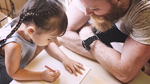 Father and daughter coloring thanks to child custody rights 