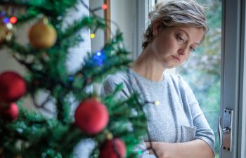 Woman next to a Christmas tree