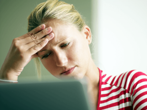 Woman looking at computer while thinking of social media and divorce