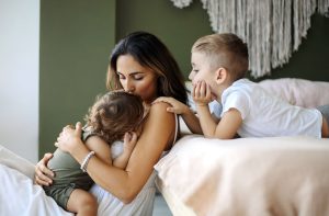 Mother spending time with her children in a bedroom
