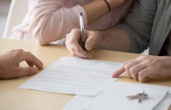 Couple renters tenants signing rental agreement renting new house Augusta, GA 