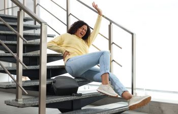 An injured Afro-American woman due to falling down the stairs in the public building